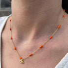 Gouden ketting met oranje kralen en boze oog hanger van Emiza Jewellery
